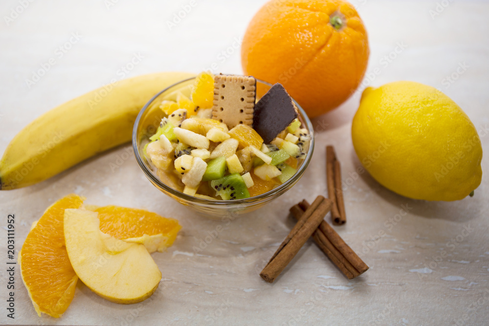 Bowl of healthy fresh fruit salad with tropical fruit background Bowl of healthy fresh fruit salad with tropical fruit background