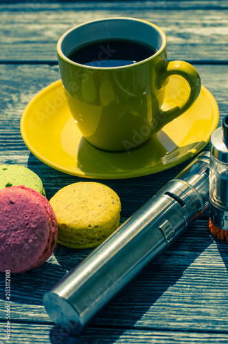 Still life with e-cig and jiuce on the wooden background photo