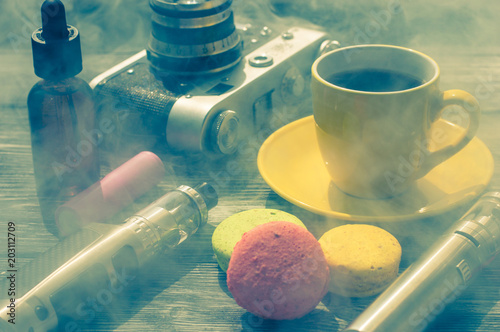 Still life with e-cig and jiuce on the wooden background photo