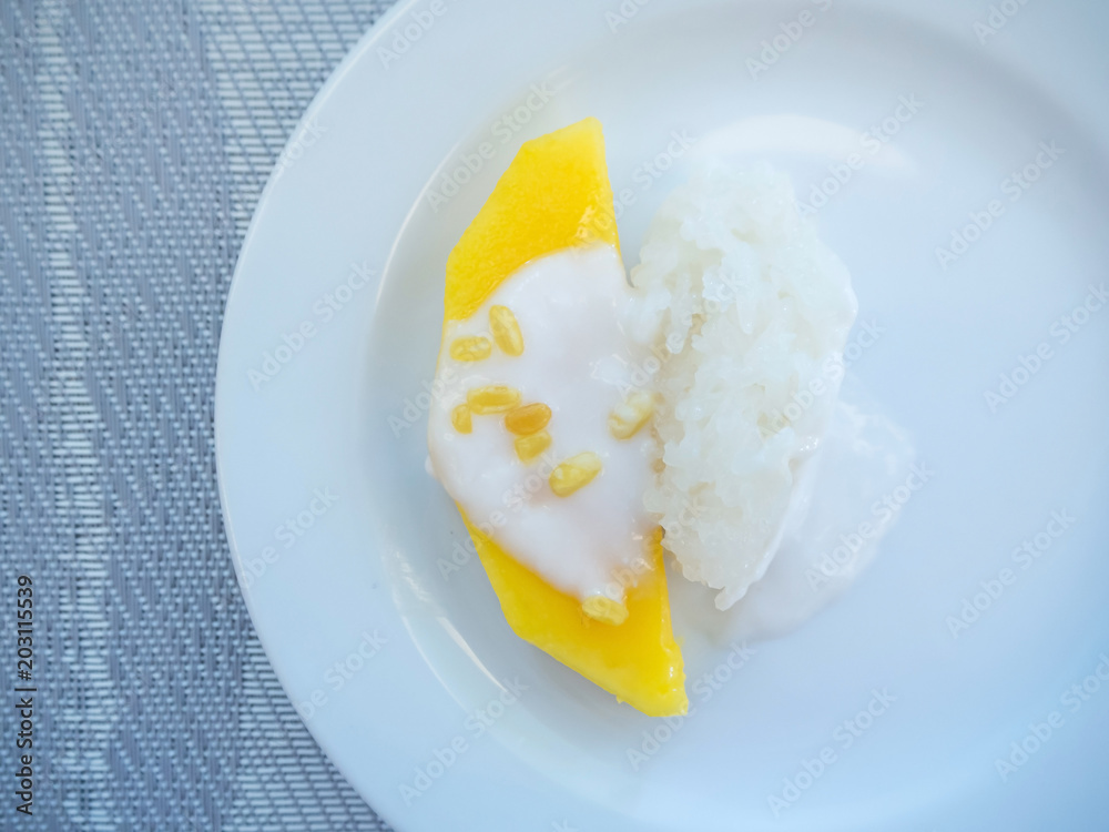 sweet mango with sticky rice with coconut milk on white plate sweet mango with sticky rice with coconut milk on white plate