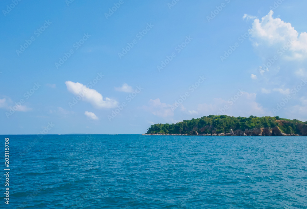 Small island in the middle of the sea and blue sky