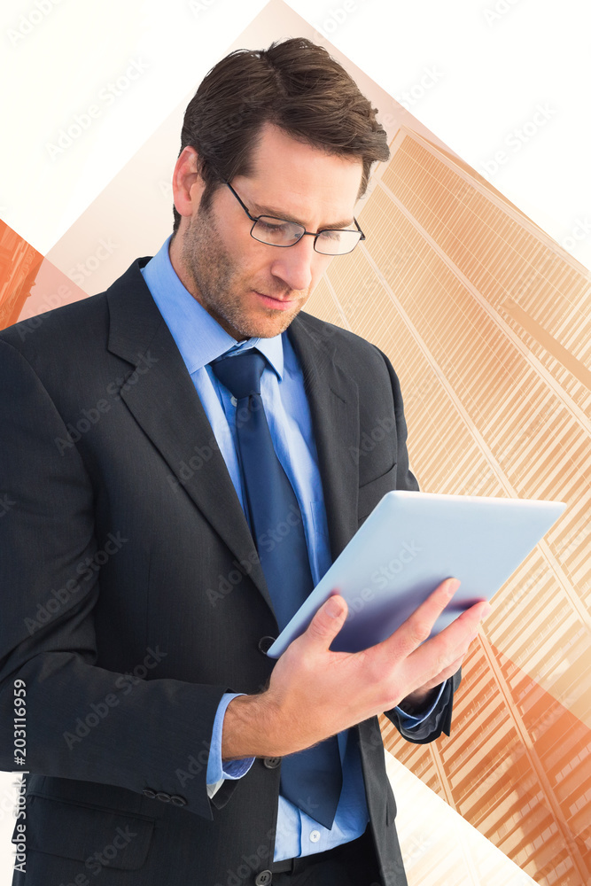 Businessman using a tablet computer against skyscraper Businessman using a tablet computer against skyscraper