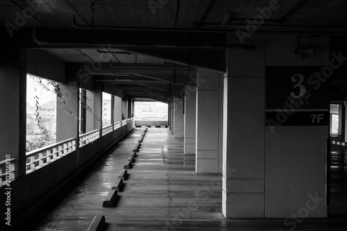 Abstract Black and White image rows of empty space car parking lot. (Selective focus)