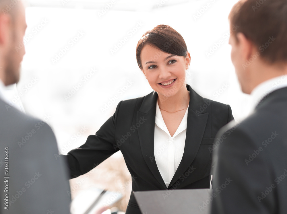 smiling businesswoman showing colleague information on the flipchart. smiling businesswoman showing colleague information on the flipchart.
