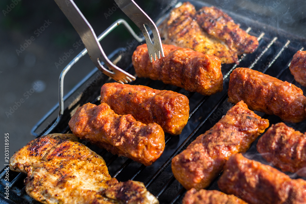Close up pf delicious chicken breast on wooden skew with fresh vegetables, garlic, paprika fried on mangal barbeque grill Close up pf delicious chicken breast on wooden skew with fresh vegetables, garlic, paprika fried on mangal barbeque grill