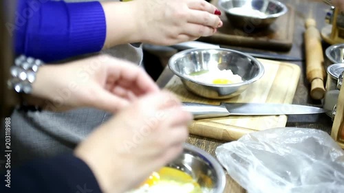 Wallpaper Mural Female hands break eggs into metal bowls with flour in the master class Torontodigital.ca