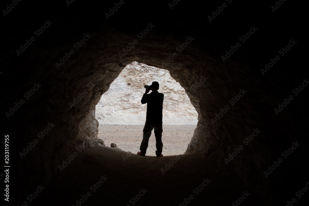 Fototapeta premium young photographer making photos in a cave
