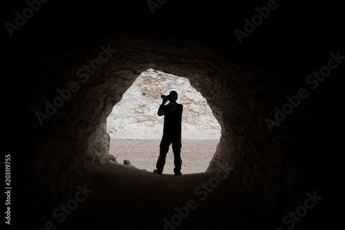young photographer making photos in a cave