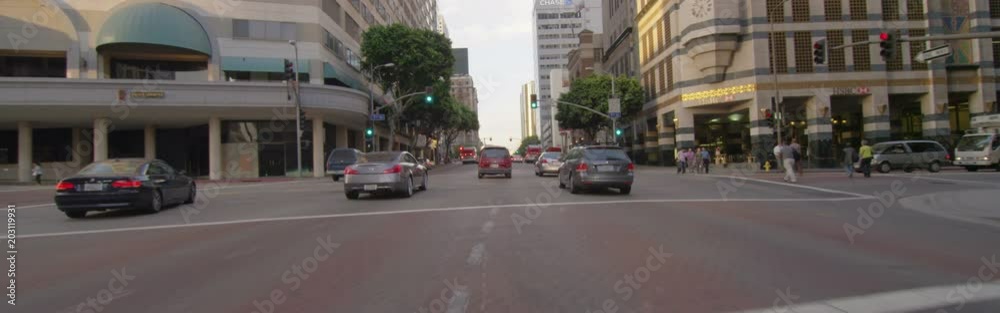 Front view of a Driving Plate: Car travels on Figueroa Street in Los Angeles from 7th Street to 1st Street at sunset.