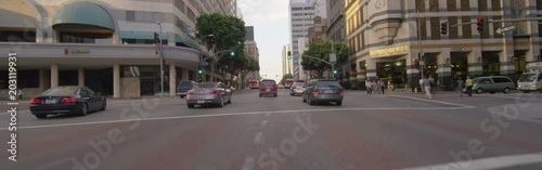 Front view of a Driving Plate: Car travels on Figueroa Street in Los Angeles from 7th Street to 1st Street at sunset. photo