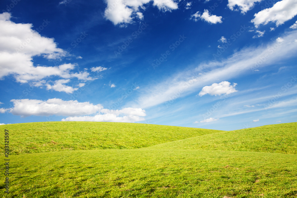 Grassy hills under amazing sky background