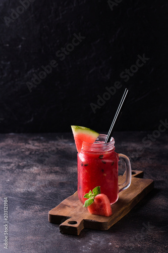 Fresh watermelon Smoothie in the Mason jar on dark background