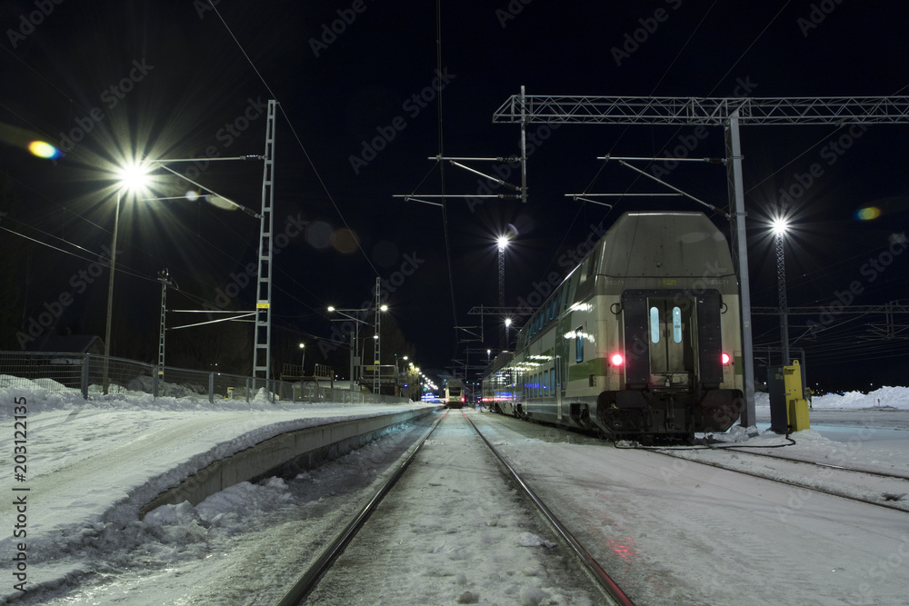 Snowed railway at night