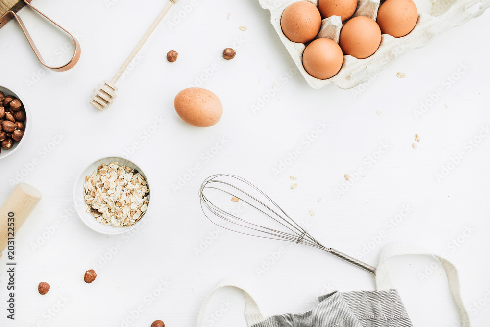Flat lay, top view of raw healthy food ingredients. Cutting board, hazelnuts, eggs, cereals. Cooking concept. Flat lay, top view of raw healthy food ingredients. Cutting board, hazelnuts, eggs, cereals. Cooking concept.