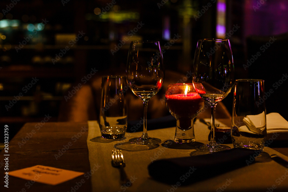 Two wine glasses and defocused lights at the restaurant