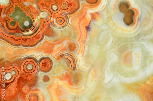 Surface of an onyx plate. Texture pattern for tiles. The texture of kind of agate stone. Circular stains on structure of stone. 