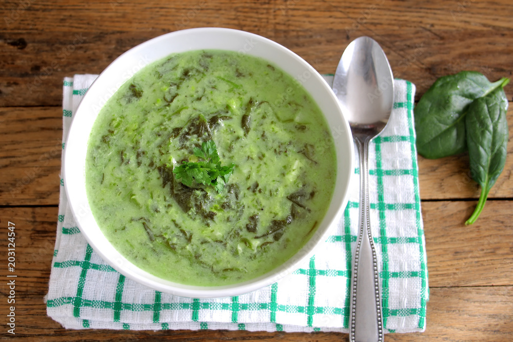 Fresh spinach soup in white bowl. Top view. Fresh spinach soup in white bowl. Top view.