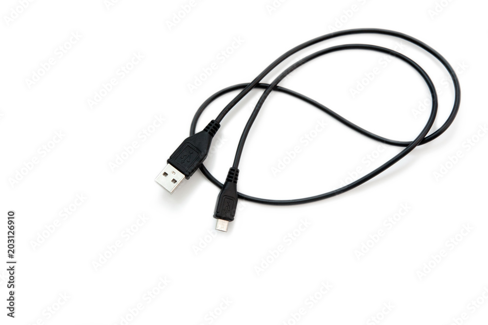 Black USB cable on white background. USB and USB-mini cable connectors close-up. A patch cable or patch cord or patch lead. Black USB cable on white background. USB and USB-mini cable connectors close-up. A patch cable or patch cord or patch lead.
