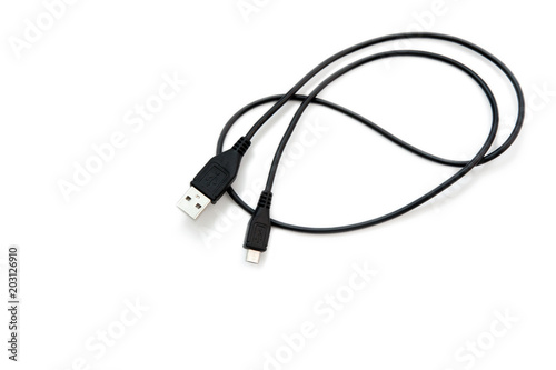 Black USB cable on white background. USB and USB-mini cable connectors close-up. A patch cable or patch cord or patch lead.