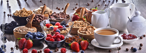 Different sorts of breakfast cereal products and fresh fruits photo