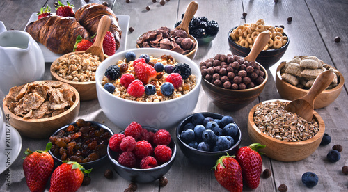 Different sorts of breakfast cereal products and fresh fruits