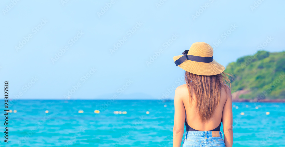 beautiful women with hat looking to the ocean in Thailand , beach vacations