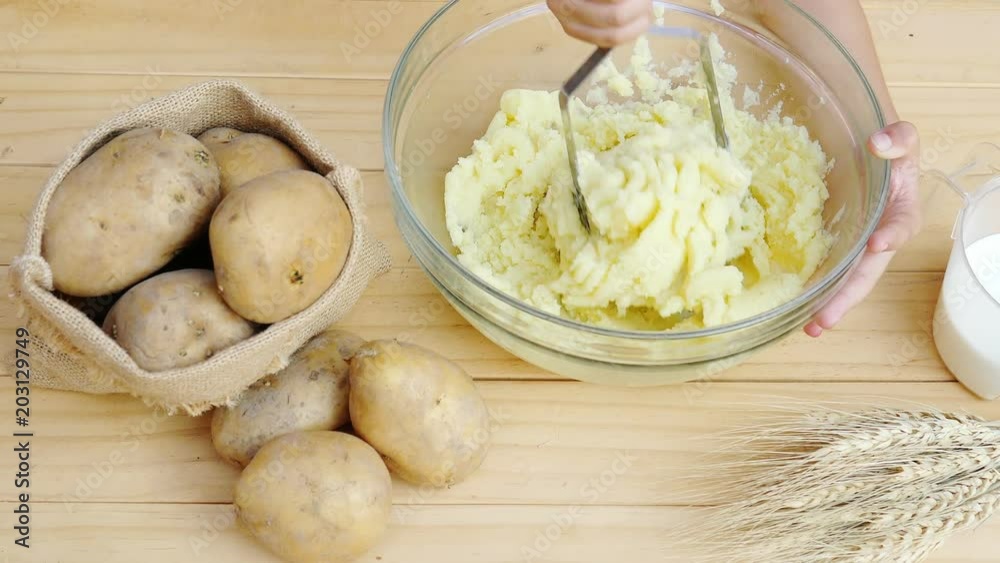 Mashed potato preparation on white wooded table - food cooking concept Mashed potato preparation on white wooded table - food cooking concept
