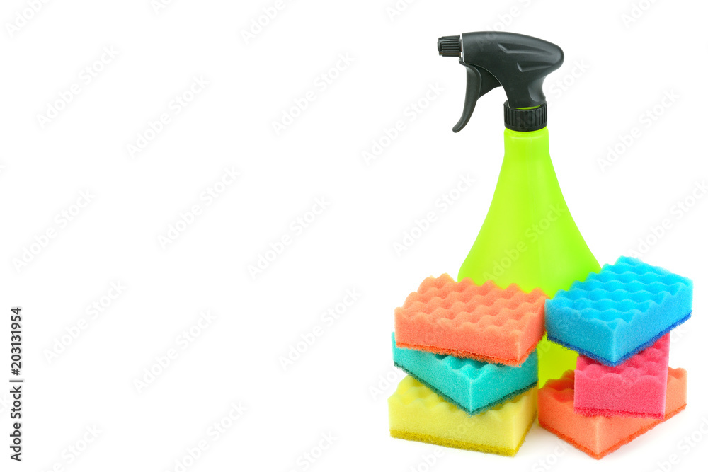 A spray of cleaning agents and household foam sponges isolated on white background. Free space for text. A spray of cleaning agents and household foam sponges isolated on white background. Free space for text.