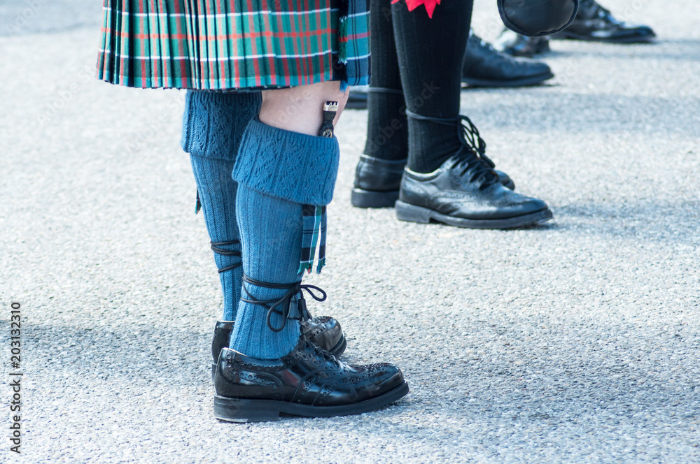 closeup of men legs with scottish kilt in the street