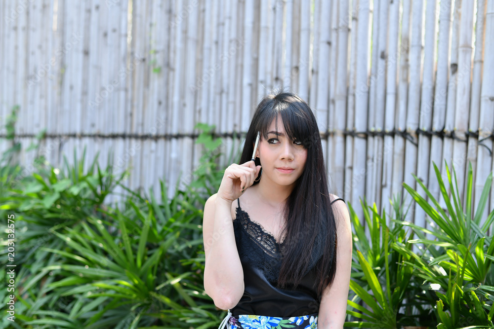 Education Concepts. Asian women reading books in the park. Beautiful women are relaxing in the park. Beautiful women are happy to read. Education Concepts. Asian women reading books in the park. Beautiful women are relaxing in the park. Beautiful women are happy to read.