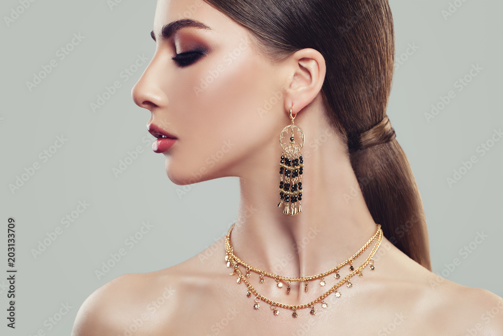 Elegant Woman with Gold Jewelry Earrings and Chain, Close up Portrait