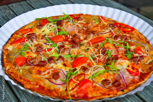 juicy tasty pizza with cheese and hunting sausages