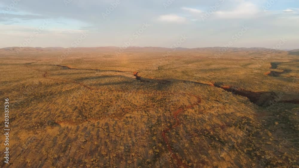 Wide aerial view of the desert in Australia flying high over Karijini. Wide aerial view of the desert in Australia flying high over Karijini.