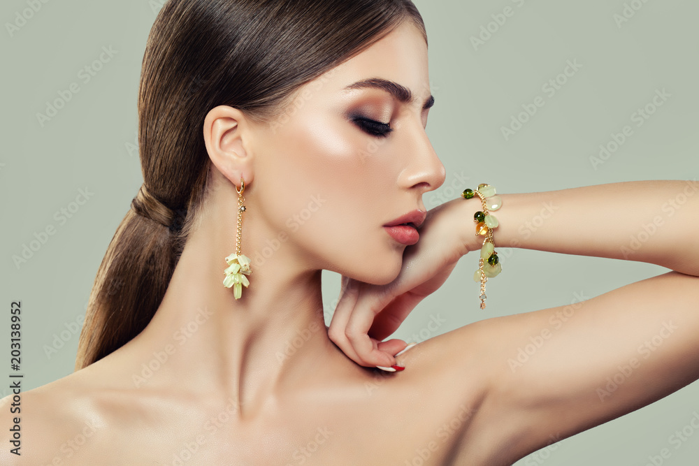 Glamurous Woman with Makeup, Healthy Hair, Jewelry Earrings and Bracelet