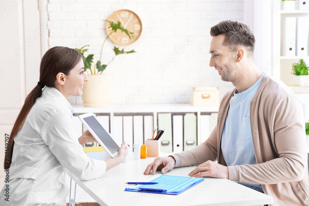 Female doctor consulting patient in clinic Female doctor consulting patient in clinic
