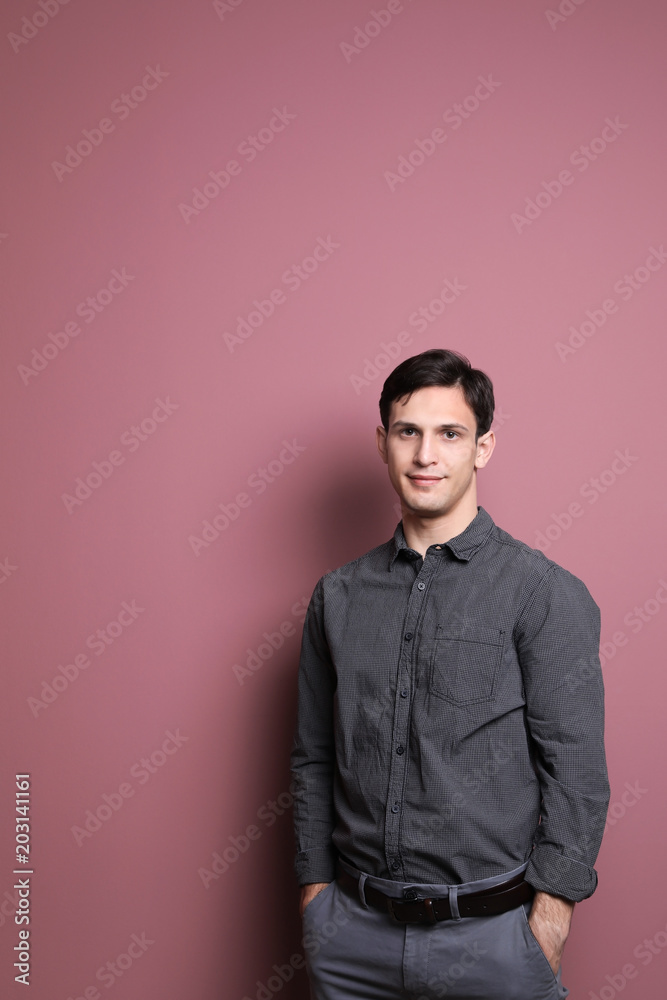 Obraz premium Portrait of confident young man on color background