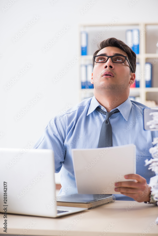 Extremely busy businessman working in office Extremely busy businessman working in office
