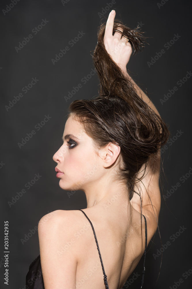 Fototapeta premium Beauty Woman Face. Closeup Of Beautiful Young Female Model With Fresh Natural Skin And Professional Facial Makeup On black Background. Portrait Of Girl With Glamour Hair Style. High Resolution