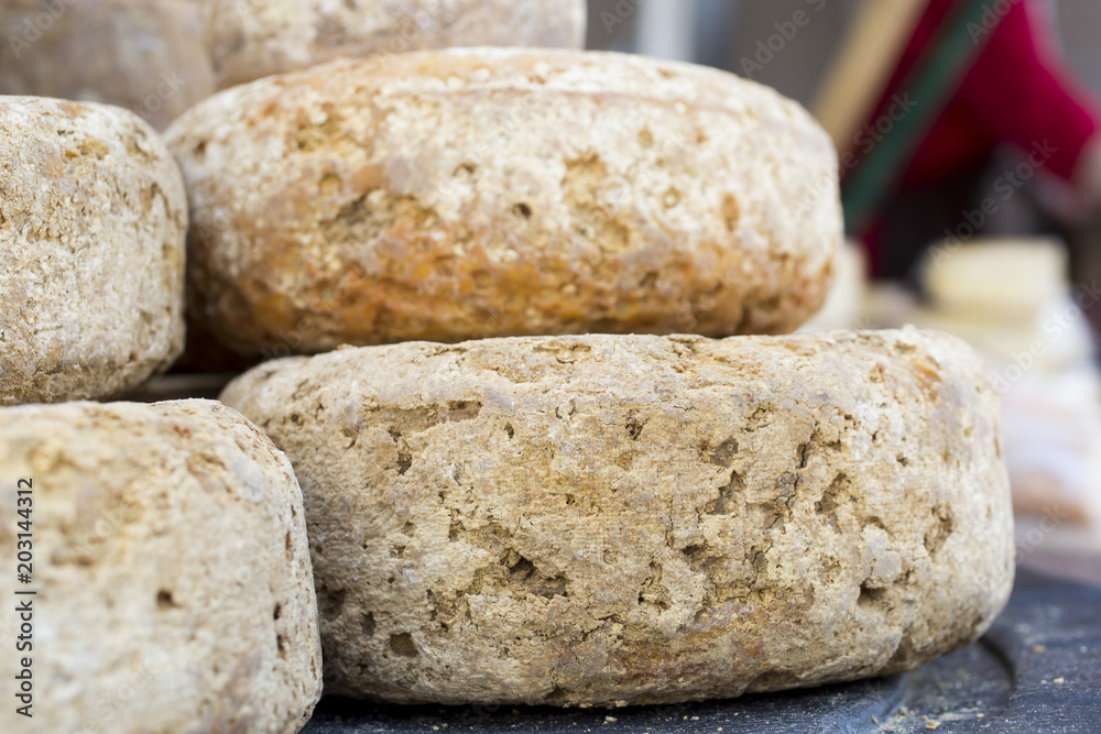 rustic french cheese wheels stacked on the marketplace rustic french cheese wheels stacked on the marketplace