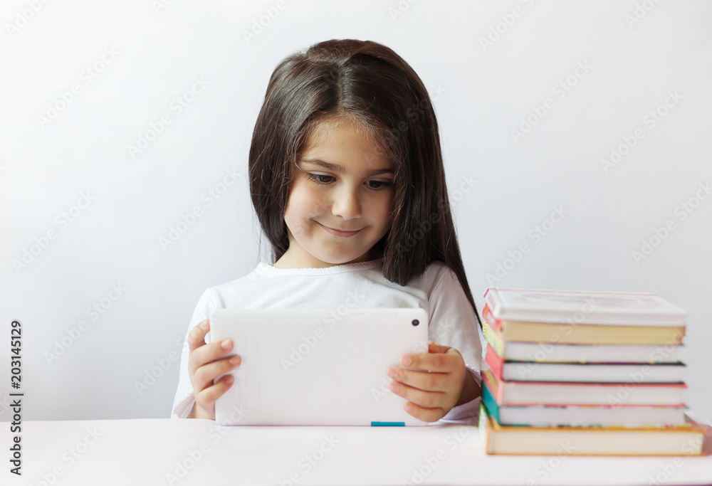leisure, childhood, technology and people concept - cute little girl child with gadget. Toned image. leisure, childhood, technology and people concept - cute little girl child with gadget. Toned image.