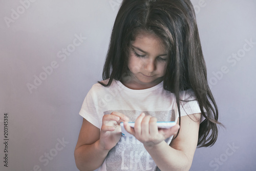 leisure, childhood, technology and people concept - child girl with tablet 
