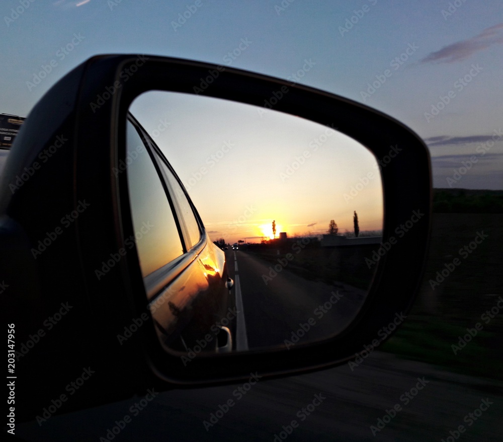 Rear view mirror reflecting sunset Rear view mirror reflecting sunset