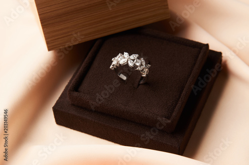 Wedding diamond ring with gift box, close-up. Luxury female jewellery, selective focus