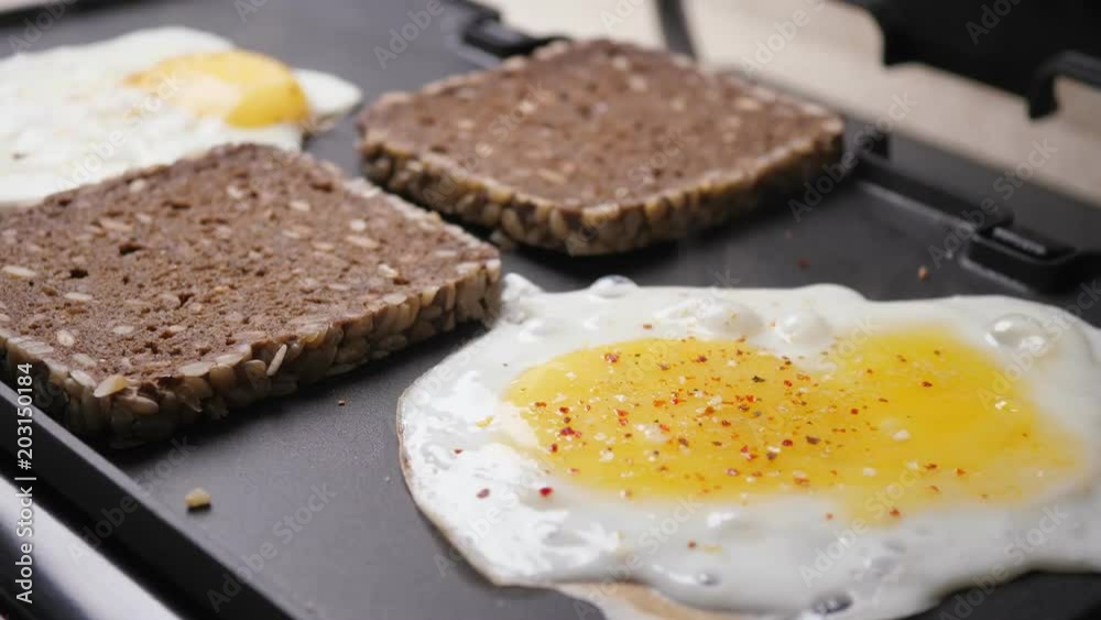 Cooking fried eggs and toasts Cooking fried eggs and toasts