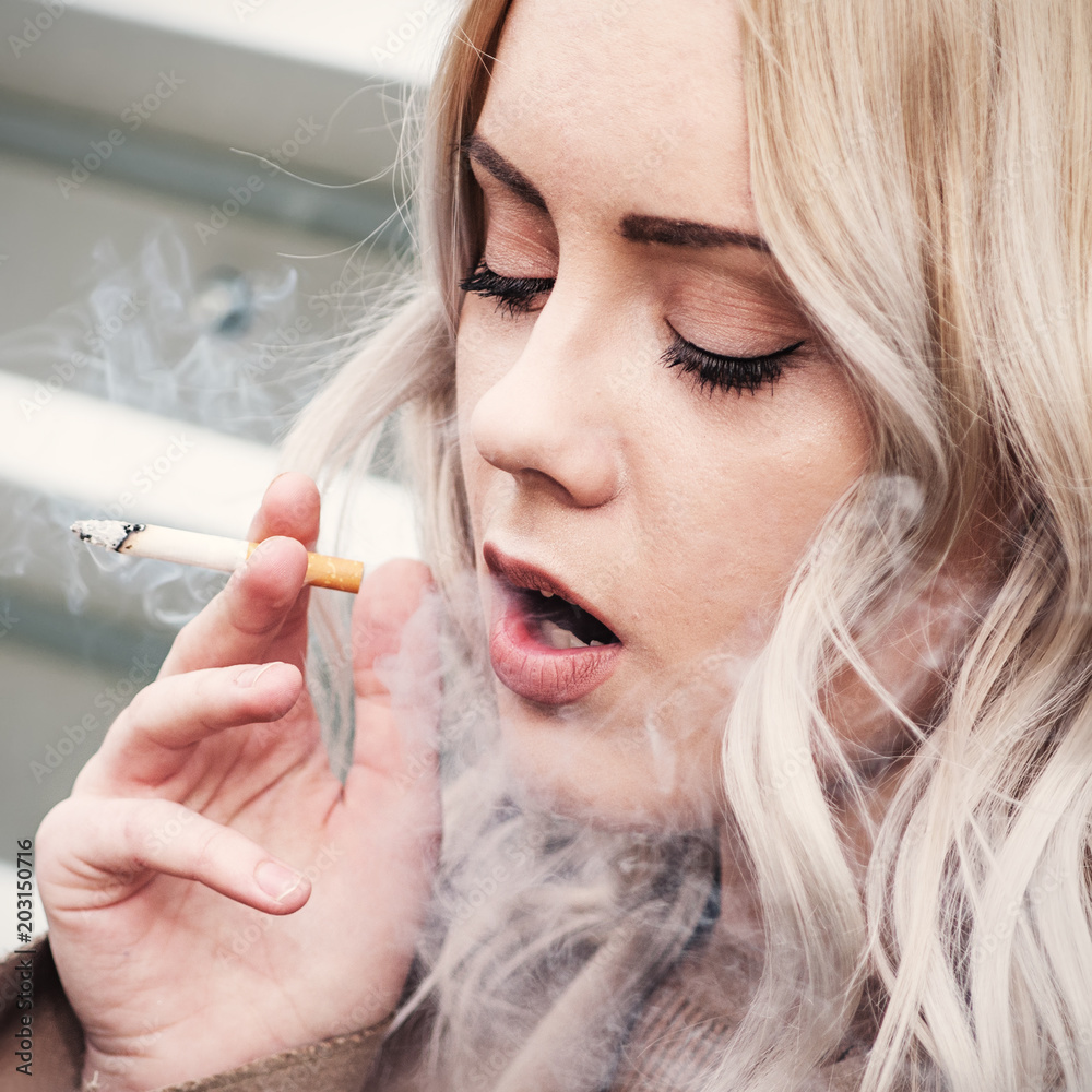 Blonde girl smoking cigarette Stock Photo | Adobe Stock