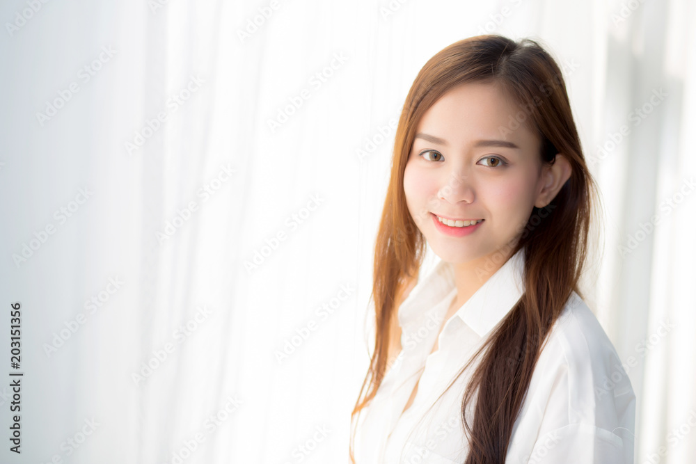 Portrait of beautiful young asian woman standing the window and smile while wake up with sunrise at morning, lifestyle and relax concept. Portrait of beautiful young asian woman standing the window and smile while wake up with sunrise at morning, lifestyle and relax concept.