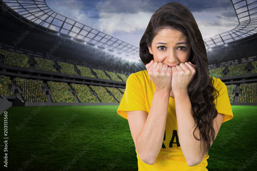 Φωτογραφία Nervous football fan in brasil tshirt in a large football stadium with fans in y