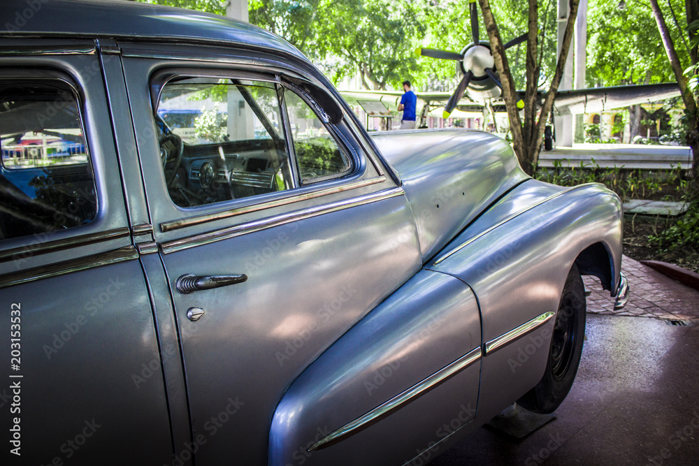 Fototapeta premium Havana, Cuba, 10 February 2018: American antique car, vintage style, rolling through the streets of Havana, Cuba