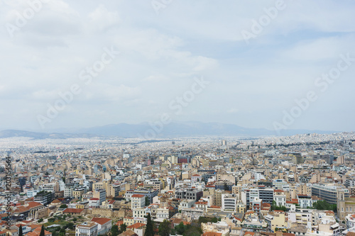 View from above on the streets and roofs of the houses of a modern European city. Athens summer day from a height.