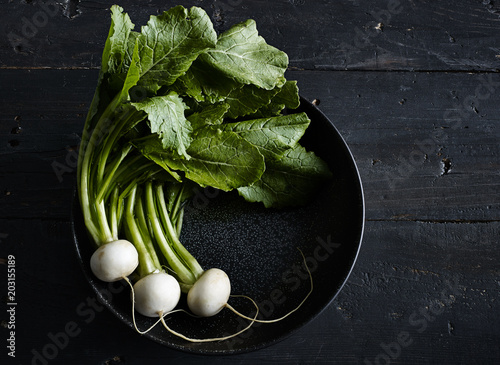 Overhead view of white radishes in pan on table